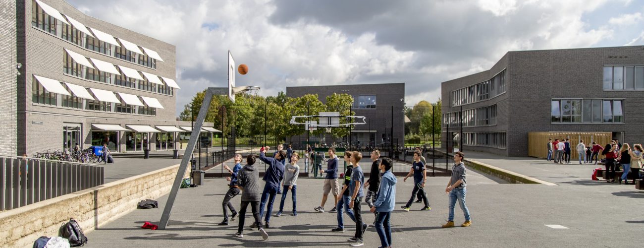 Kids playing basketball on campus