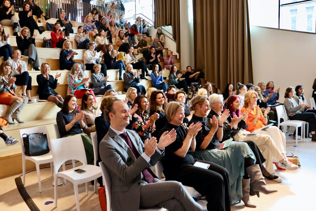 Audience sitting and clapping