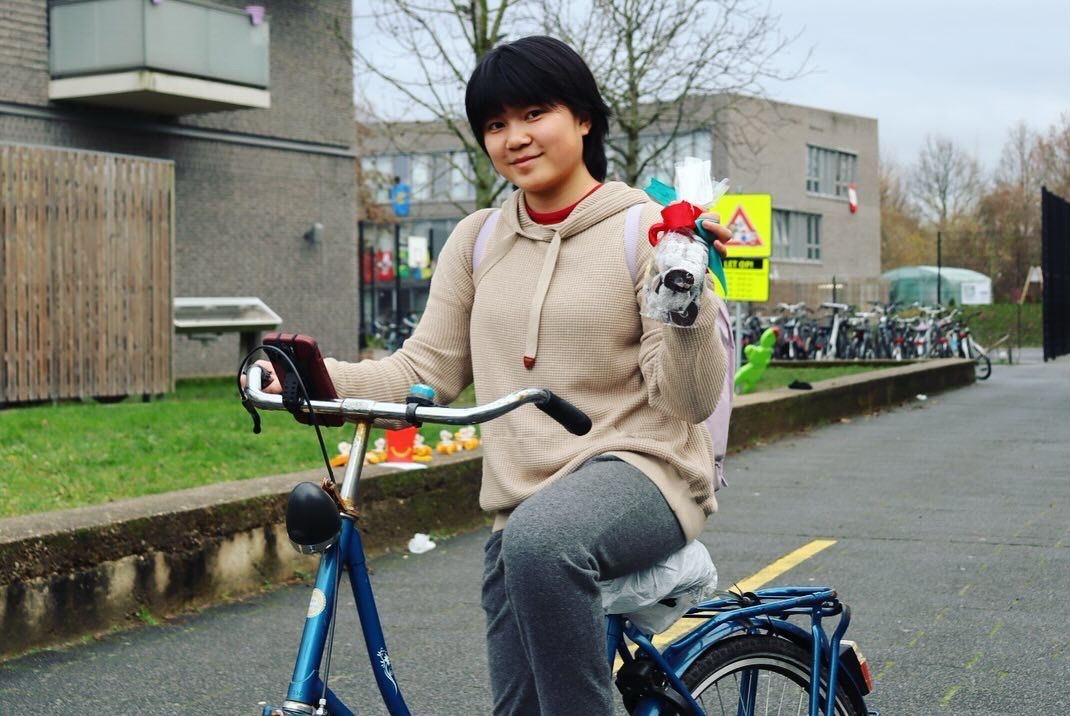 Student with treats on bike