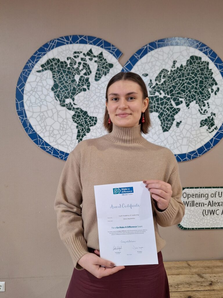 Student holding a certificate