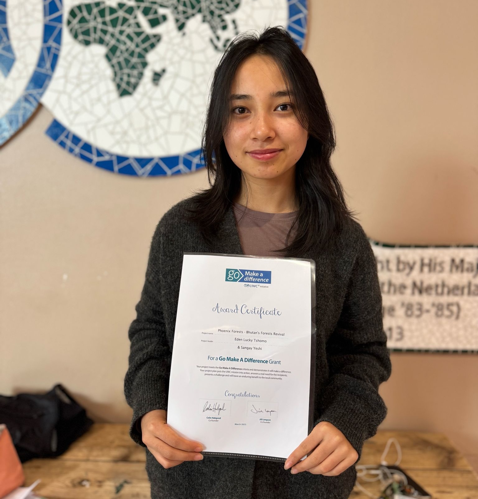 Student Eden holding her certificate for the GoMAD funding