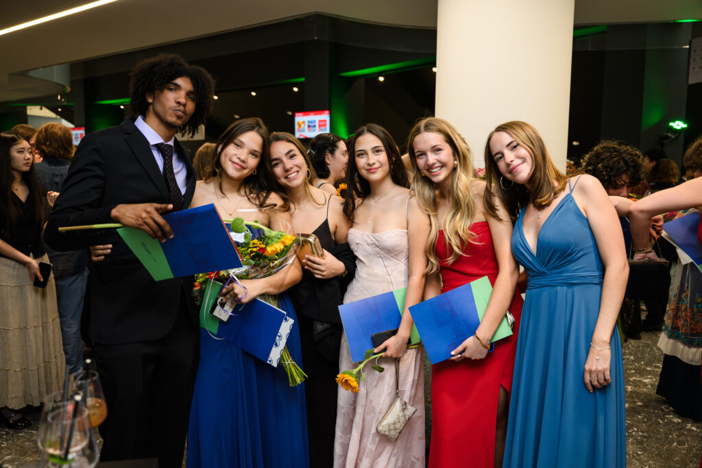 Students posing with diplomas