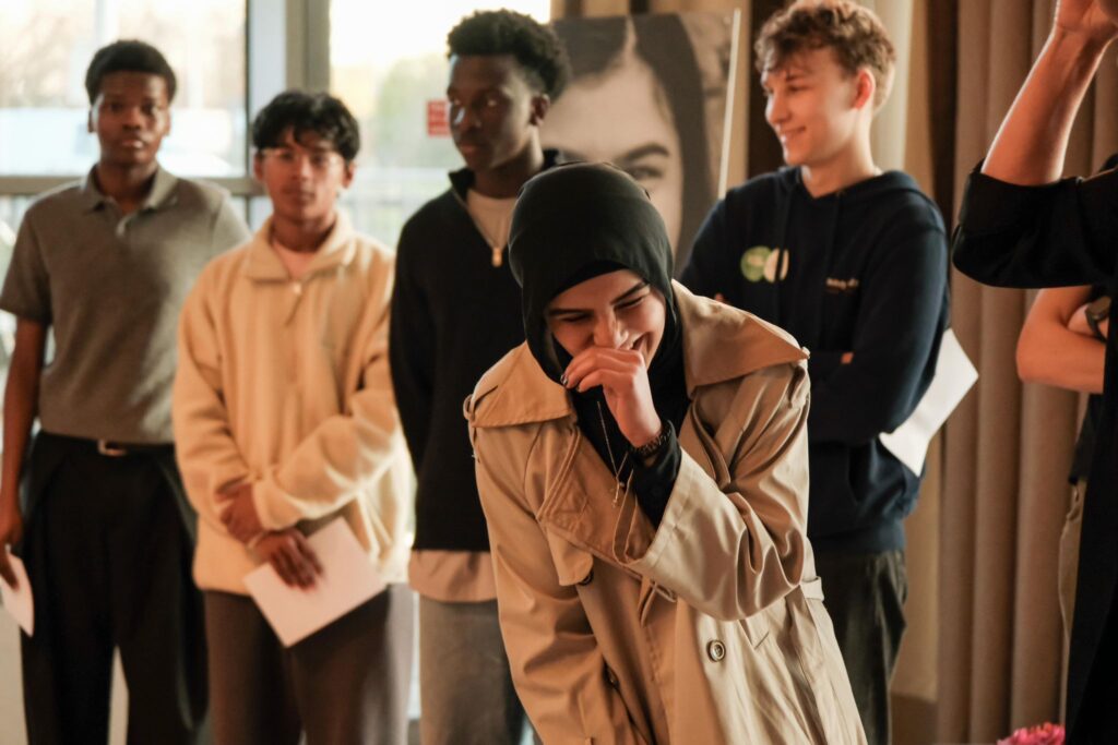 Student laughin in front of group