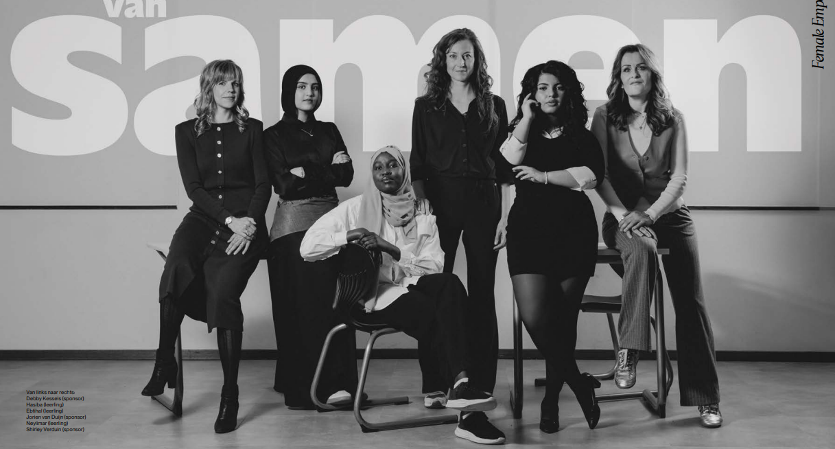 Women and students pose together